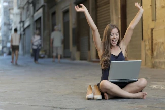 Woman using laptop sat outside